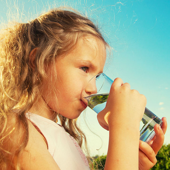 Young Girl Drinking Water from a Glass